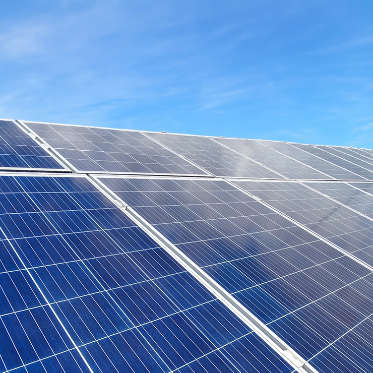 A PV system on a roof with a blue sky