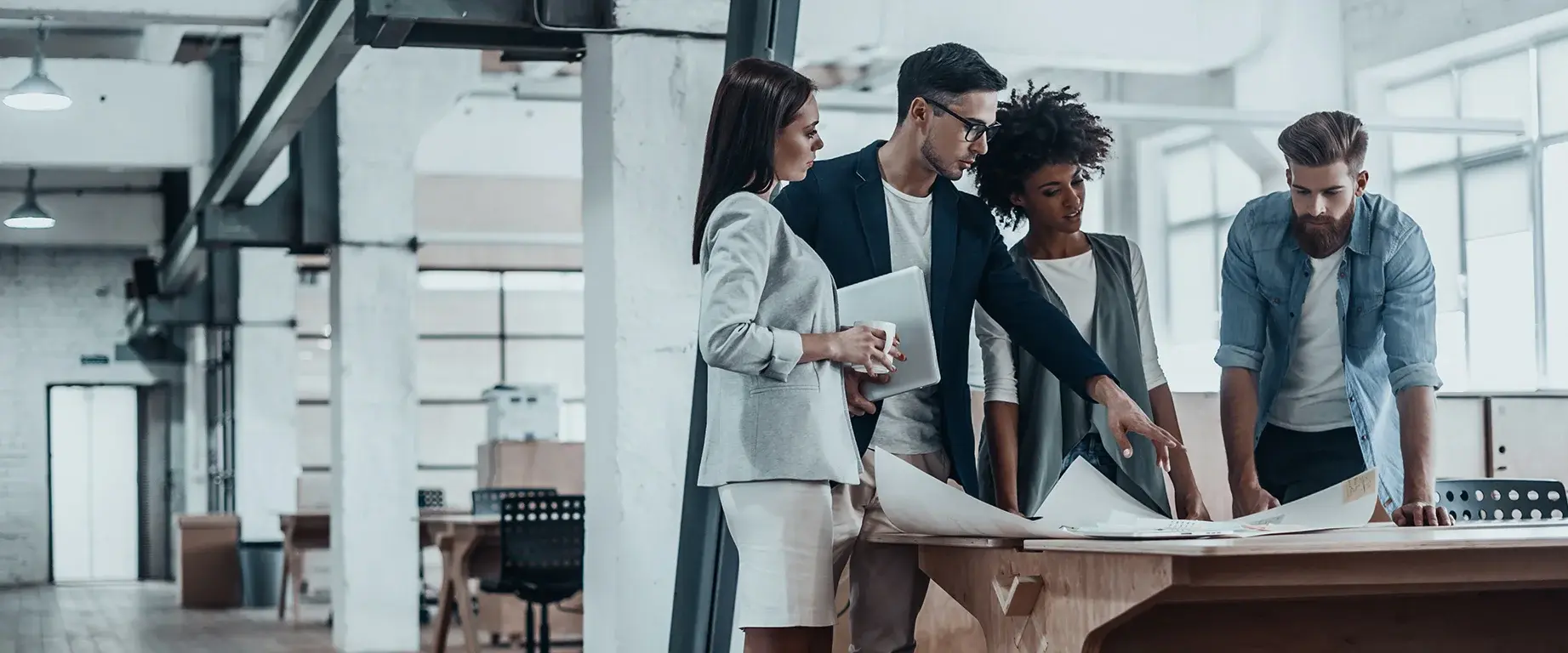 Office building with 4 people planning something together